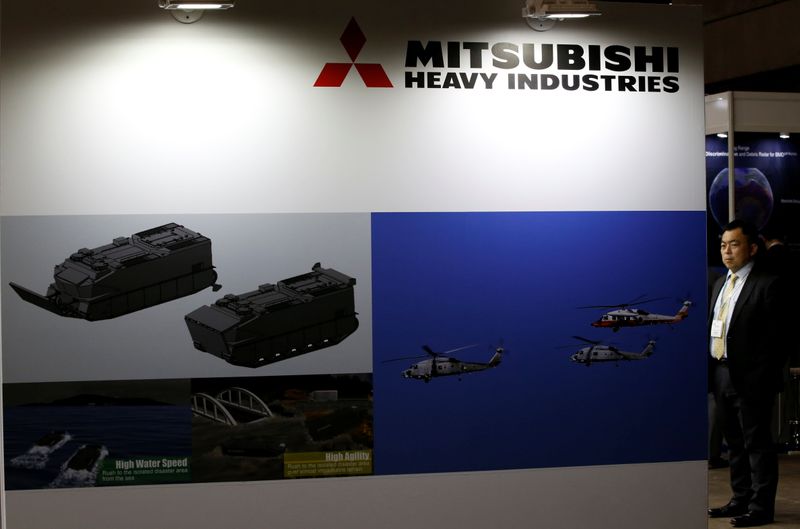 Visitor is seen at Mitsubishi Heavy Industries' booth during the MAST show in Chiba