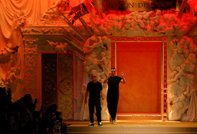 Italian designers Domenico Dolce and Stefano Gabbana acknowledge the applause at the end of