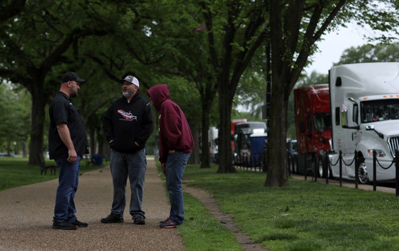 Truckers line their trucks along Constitution Ave for a protest as the outbreak of the