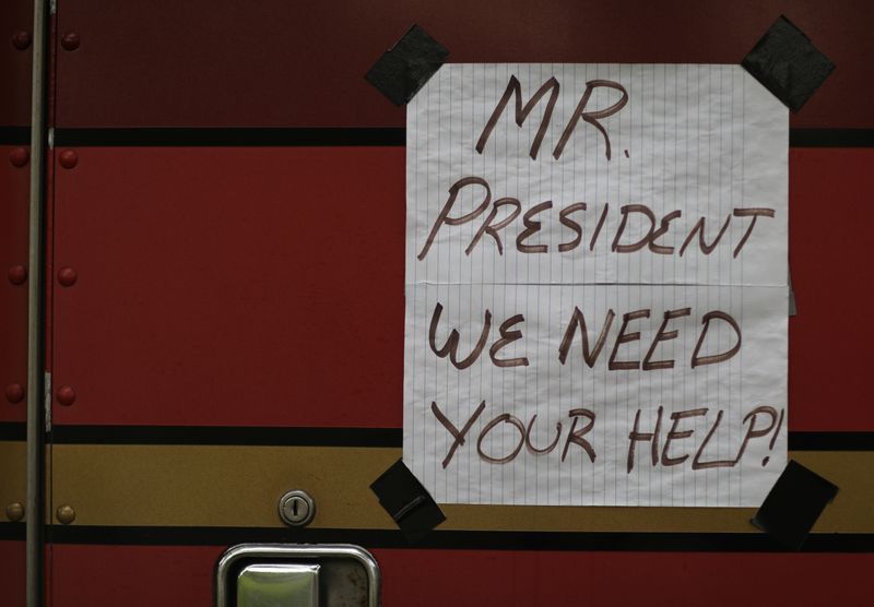 Truckers line their trucks along Constitution Ave for a protest as the outbreak of the