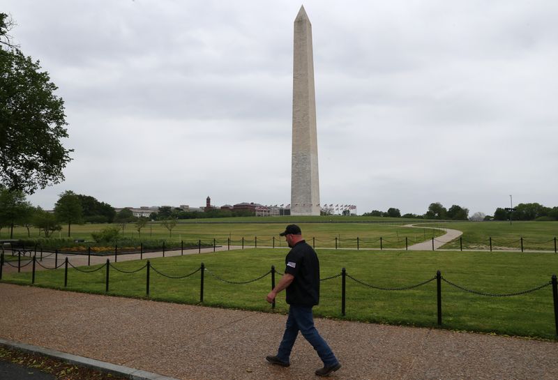 Truckers line their trucks along Constitution Ave for a protest as the outbreak of the