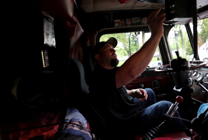 Truckers line their trucks along Constitution Ave for a protest as the outbreak of the