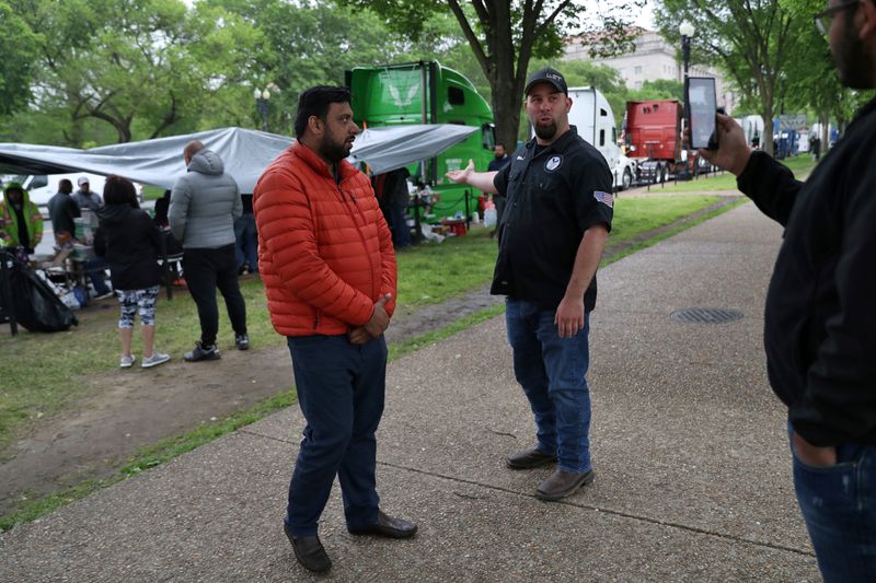 Truckers line their trucks along Constitution Ave for a protest as the outbreak of the