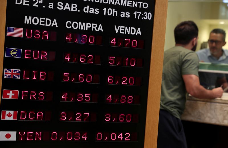FILE PHOTO: A board displays the Brazilian Real-U.S. dollar and other foreign currencies