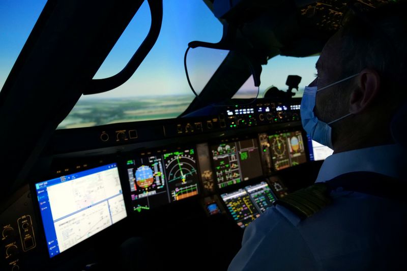 An Air France pilot trains in a flight simulator at a training centre near Paris amid COVID-19