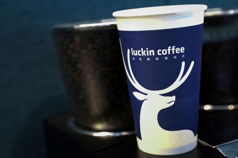 FILE PHOTO: A screen displays the logo for Luckin Coffee during the company's IPO at the Nasdaq