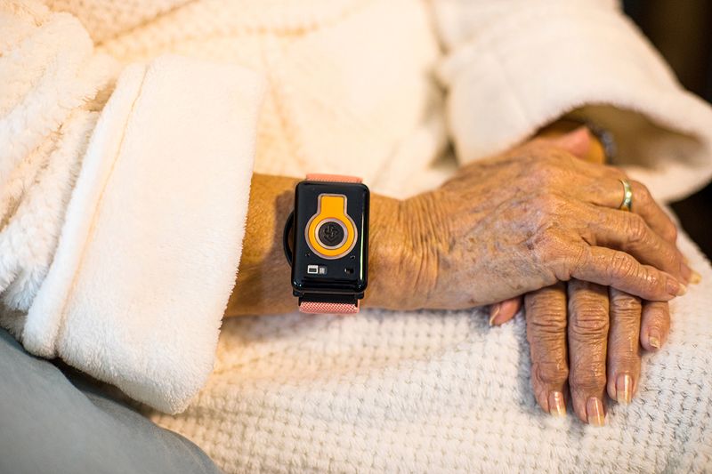 A photo illustration provided by CarePredict shows an individual wearing the company's Tempo