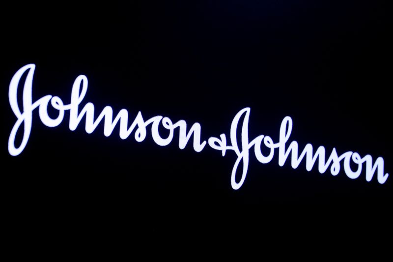 The company logo for Johnson & Johnson is displayed on a screen to celebrate the 75th