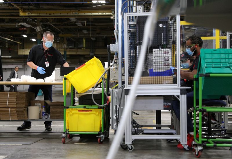 FILE PHOTO: Workers make protective face masks as U.S. President Donald Trump visits Honeywell