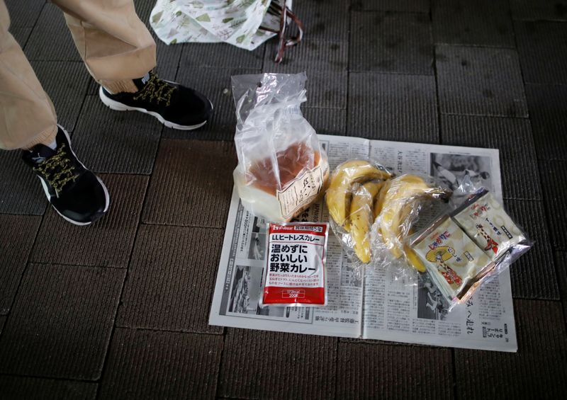 A volunteer takes part in shoes and clothes aid handouts for the needy, as the spread of the