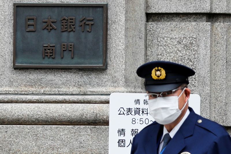 A policeman stands guard in front of the headquarters of Bank of Japan amid the coronavirus