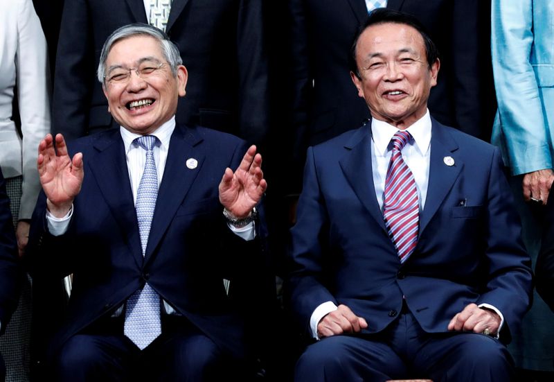 FILE PHOTO: Bank of Japan Governor Haruhiko Kuroda takes questions from reporters at the annual