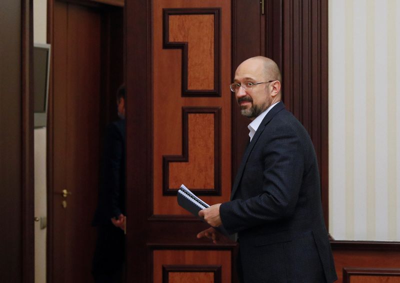 Ukraine's Prime Minister Shmygal greets a journalist during an interview in Kiev