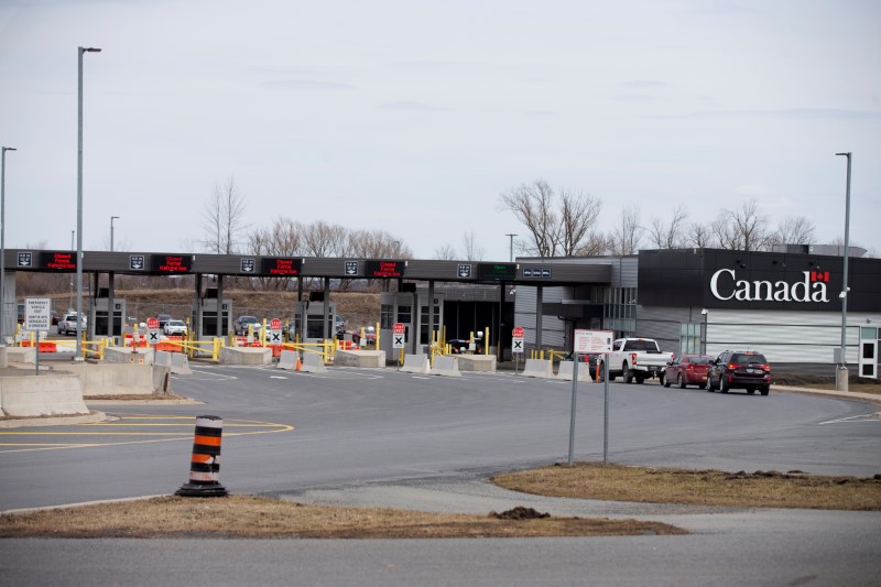 FILE PHOTO: Cars drive through Canadian customs in the border town of Cornwall