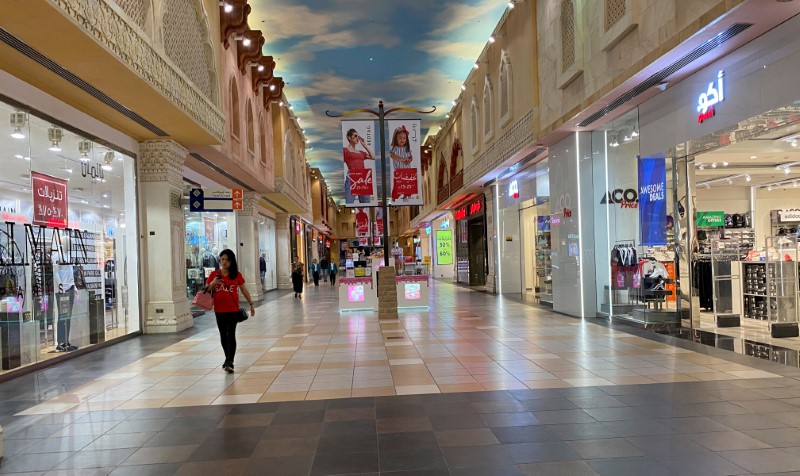 FILE PHOTO: A woman walks in an almost empty mall amid the outbreak of coronavirus disease