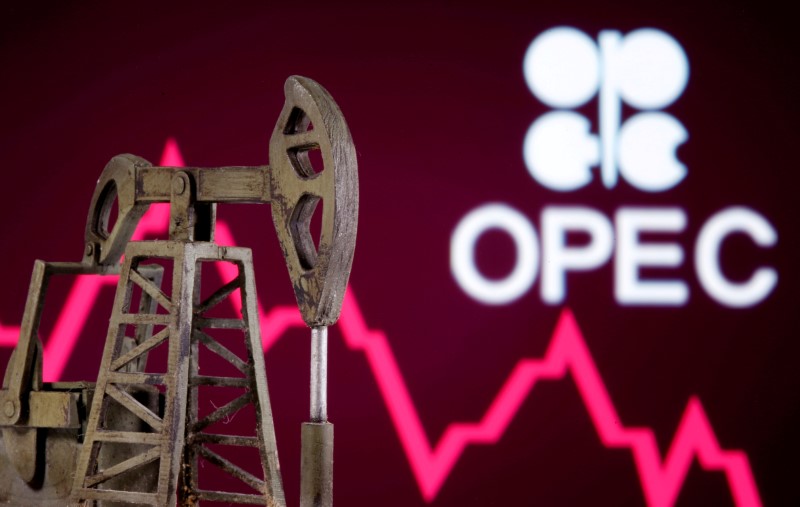 FILE PHOTO: A 3D printed oil pump jack is seen in front of displayed stock graph and Opec logo