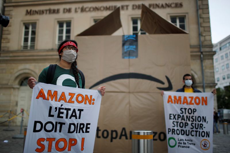Climate activists attend a demonstration against Amazon near the Bercy Finance Ministry in