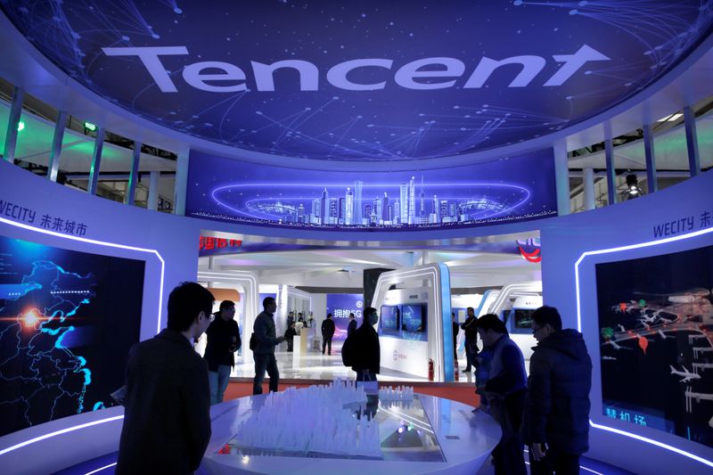 FILE PHOTO: People visit Tencent's booth at the World 5G Exhibition in Beijing