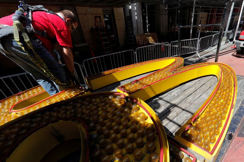 Workers remove a sign from permanently closed McDonald's restaurant in Times Square in New York