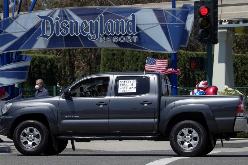 Disney cast members stage a car caravan outside Disneyland California, calling for higher