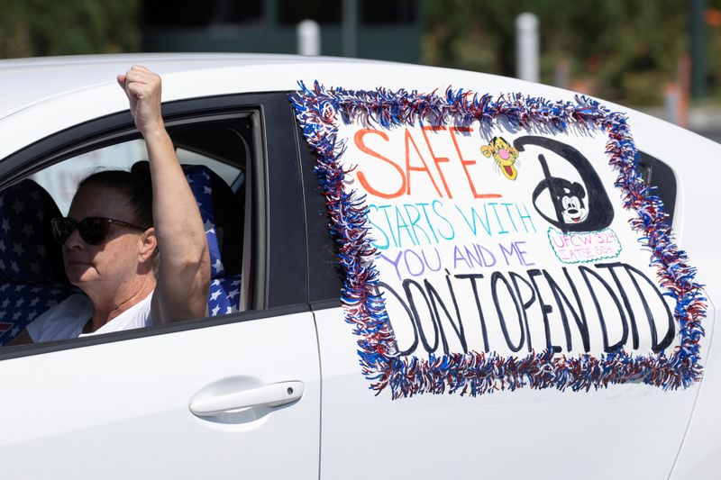 Disney cast members stage a car caravan outside Disneyland California, calling for higher
