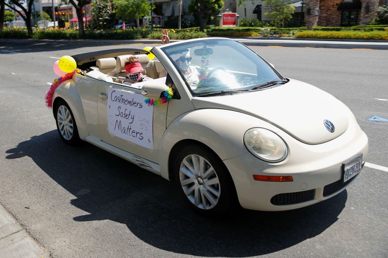 Disney cast members stage a car caravan outside Disneyland California, calling for higher