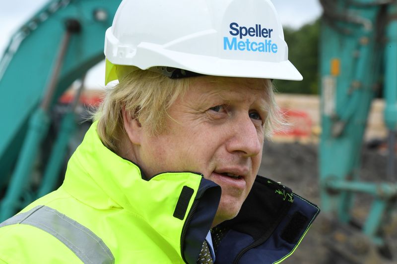Britain's Prime Minister Boris Johnson speaks with workers as he visits the Speller Metcalfe's